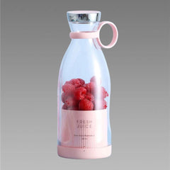 Pink and clear juice bottle with raspberries on a gray background